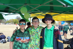 three students dressed in house colours for the athletics day